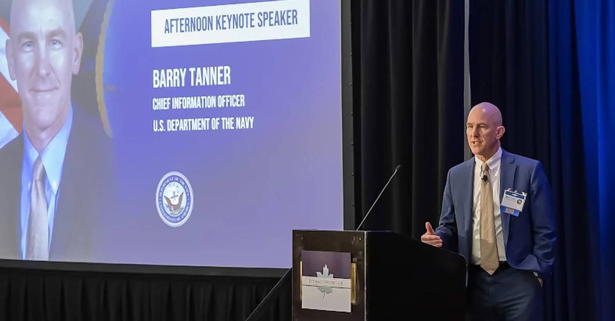 Barry Tanner. The Navy CIO brought tech and acquisition insights to the Potomac Officers Club stage.