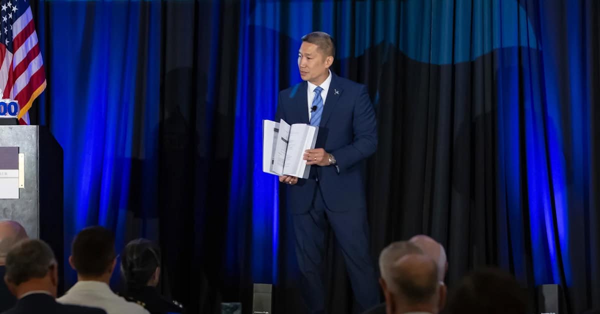 Hung Cao. The acting Navy secretary brought a prop of an old, enormous tech manual to POC's 2026 Navy Summit.